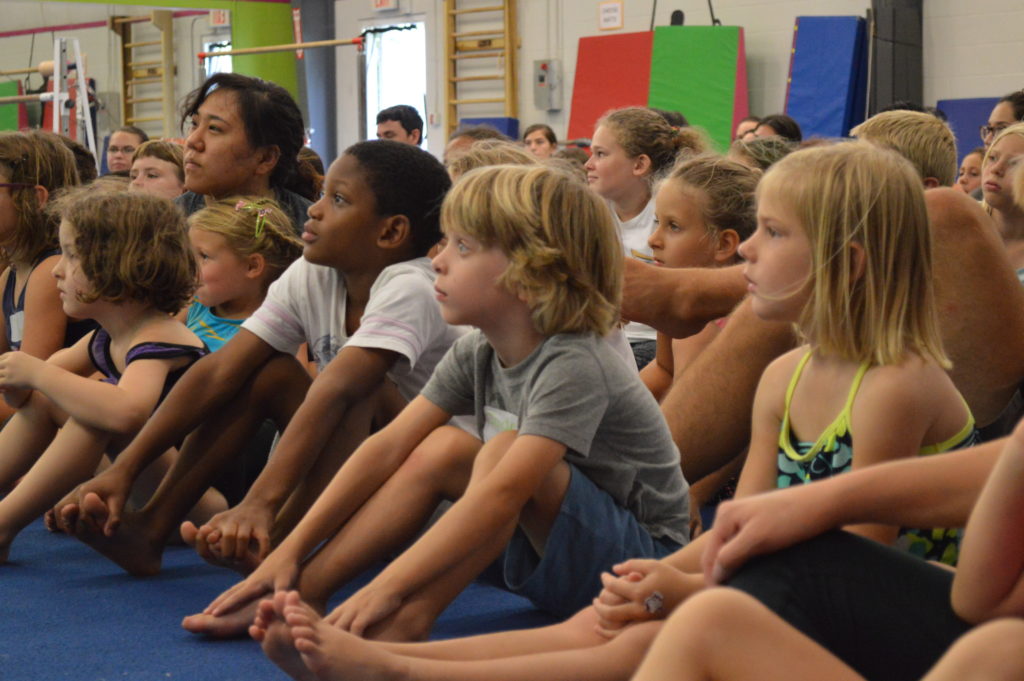 kids listening to gymnastics coach